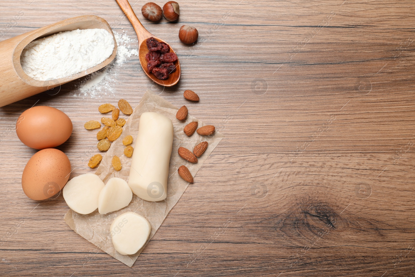 Photo of Ingredients for homemade Stollen on wooden table, flat lay. Baking traditional German Christmas bread