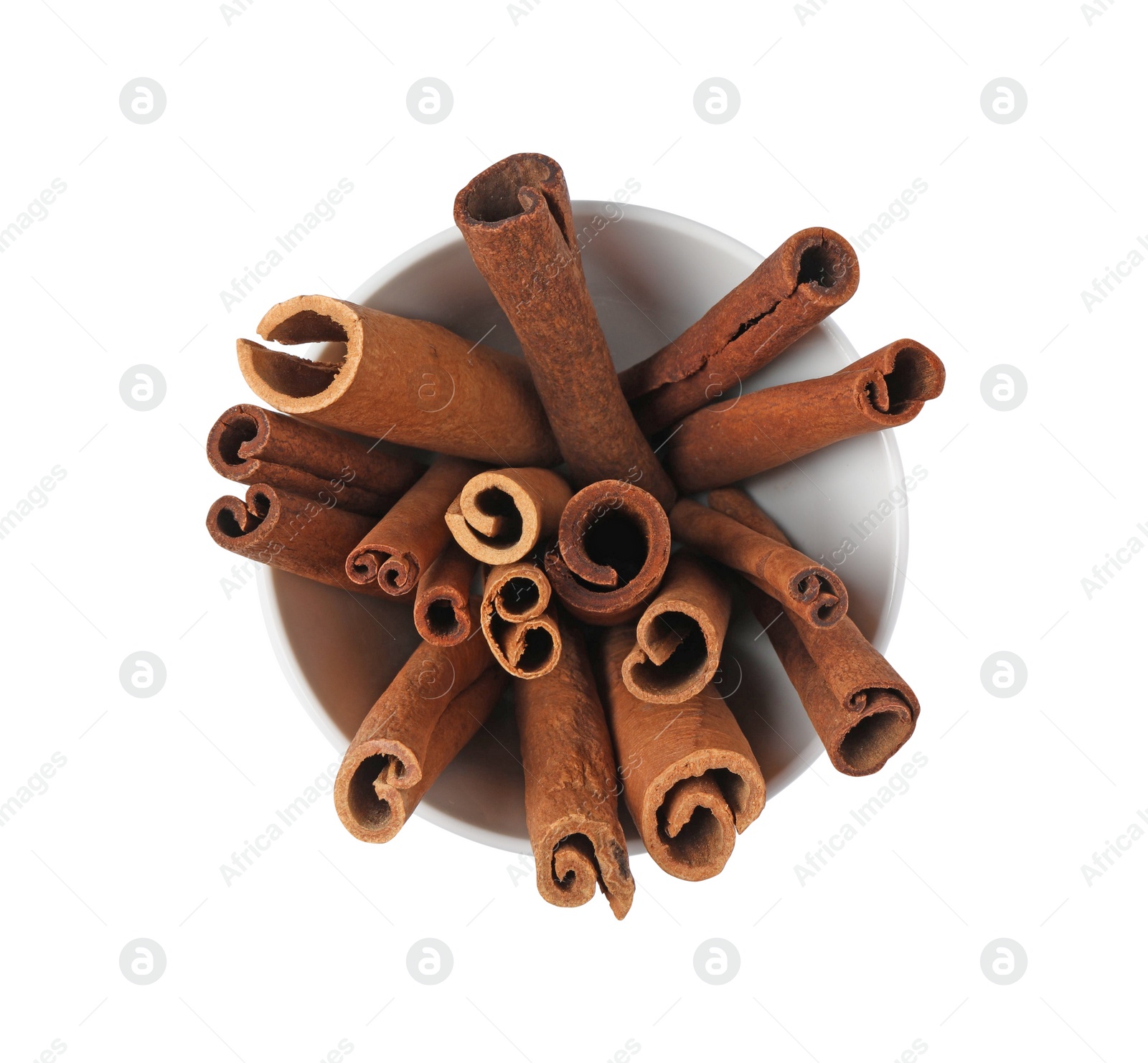 Photo of Cinnamon sticks in bowl isolated on white, top view