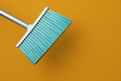 Plastic broom on color background. Space for text