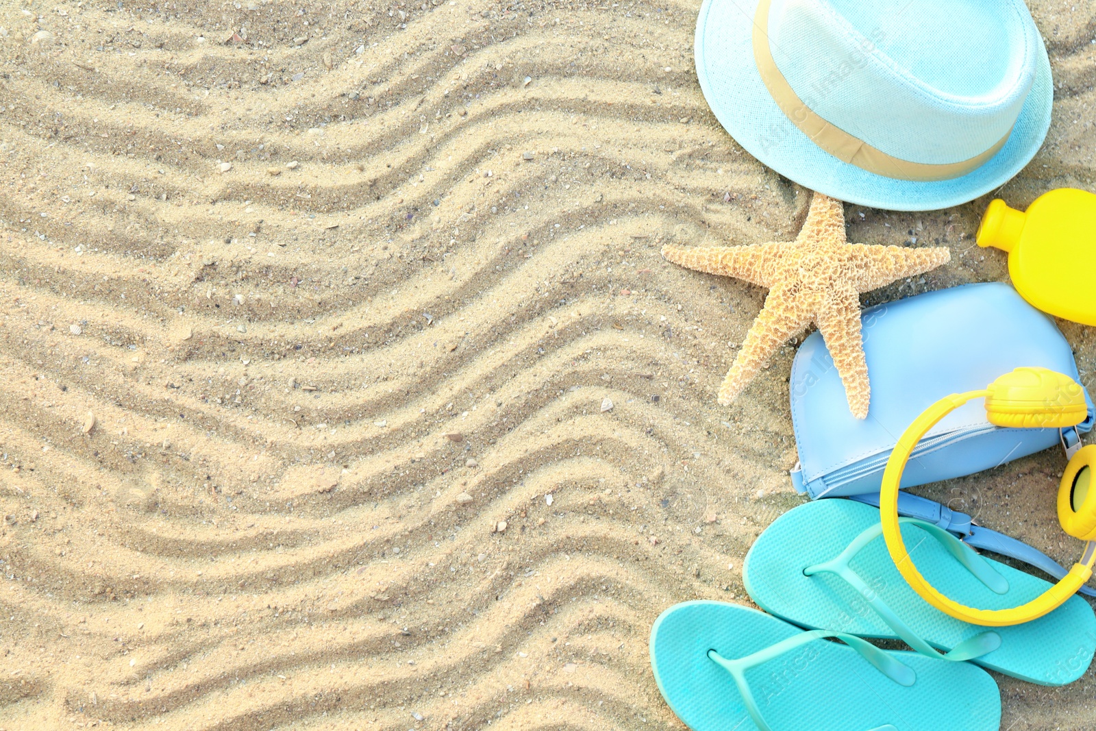 Photo of Composition with beach accessories on sand, flat lay. Space for text