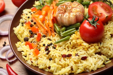 Photo of Tasty rice pilaf with vegetables on table, closeup