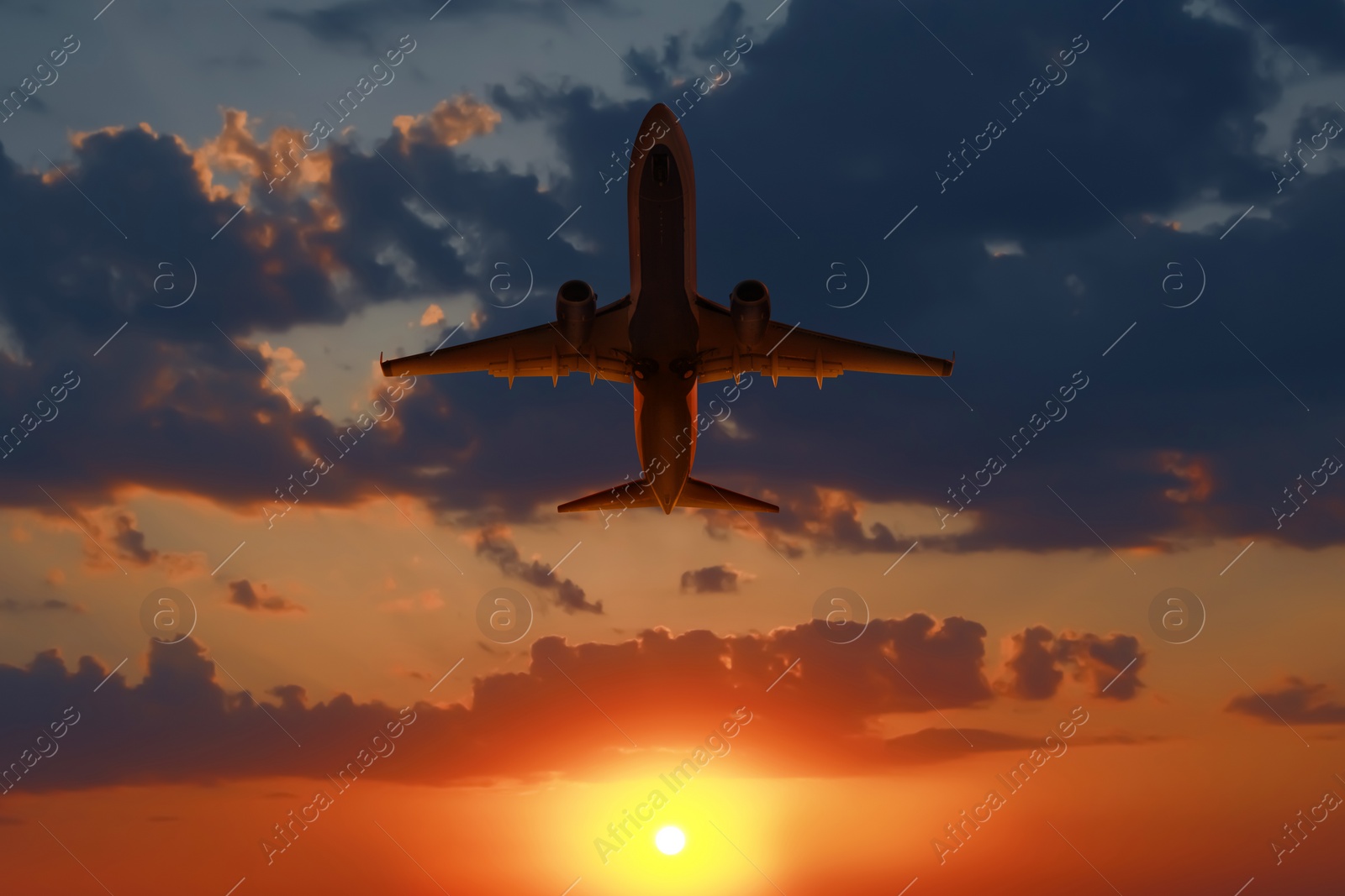 Image of Plane in sky during sunset, low angle view
