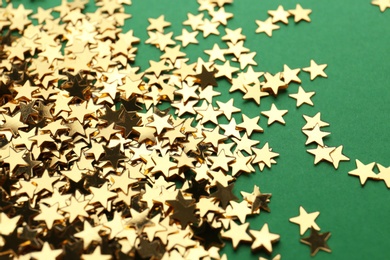 Confetti stars on green background, closeup. Christmas celebration