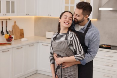 Photo of Lovely couple enjoying time together in kitchen, space for text