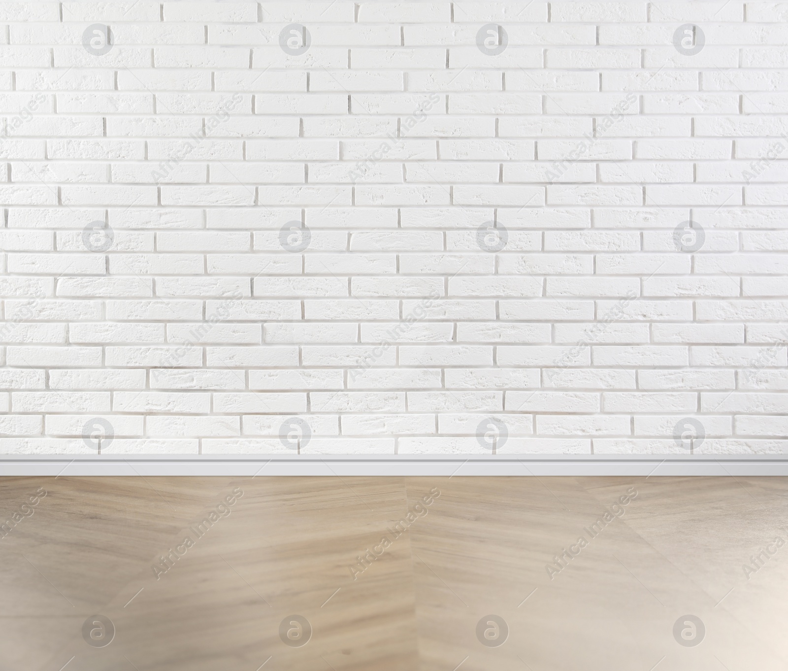 Image of Wooden floor and white brick wall indoors