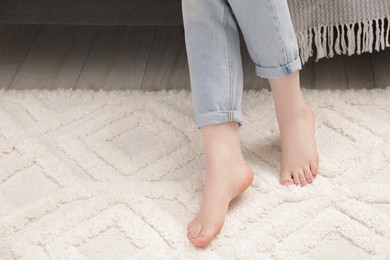 Photo of Woman on beige carpet, closeup. Space for text