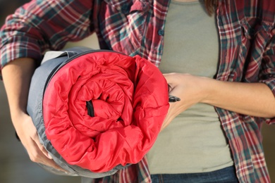 Photo of Female camper with sleeping bag outdoors, closeup