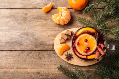 Photo of Flat lay composition with tasty mulled wine on wooden table. Space for text