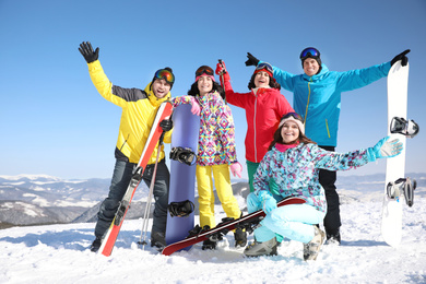 Group of friends with equipment at ski resort. Winter vacation