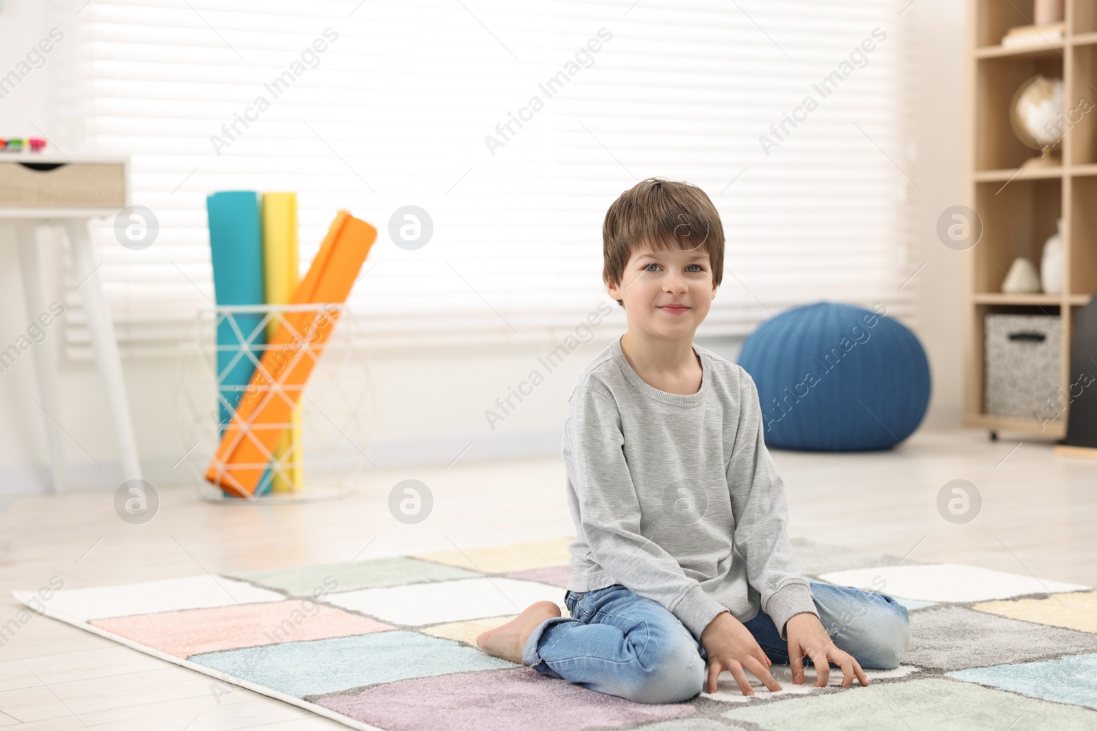 Photo of Portrait of happy boy at home, space for text