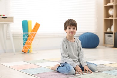 Photo of Portrait of happy boy at home, space for text