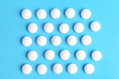 Photo of White pills on color background