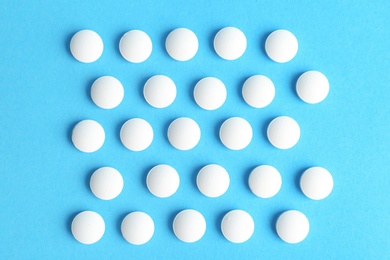 White pills on color background