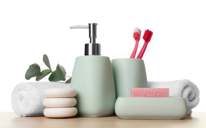 Photo of Bath accessories. Different personal care products and eucalyptus branch on wooden table against white background