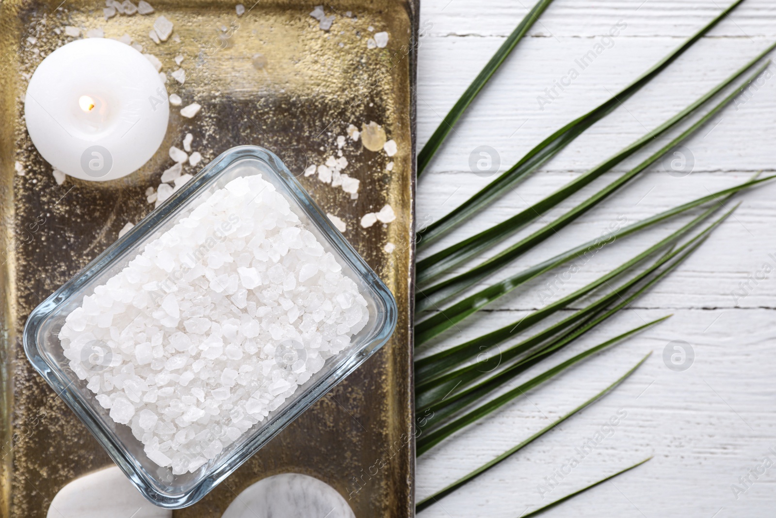 Photo of Flat lay composition with sea salt on white wooden background, space for text. Spa treatment