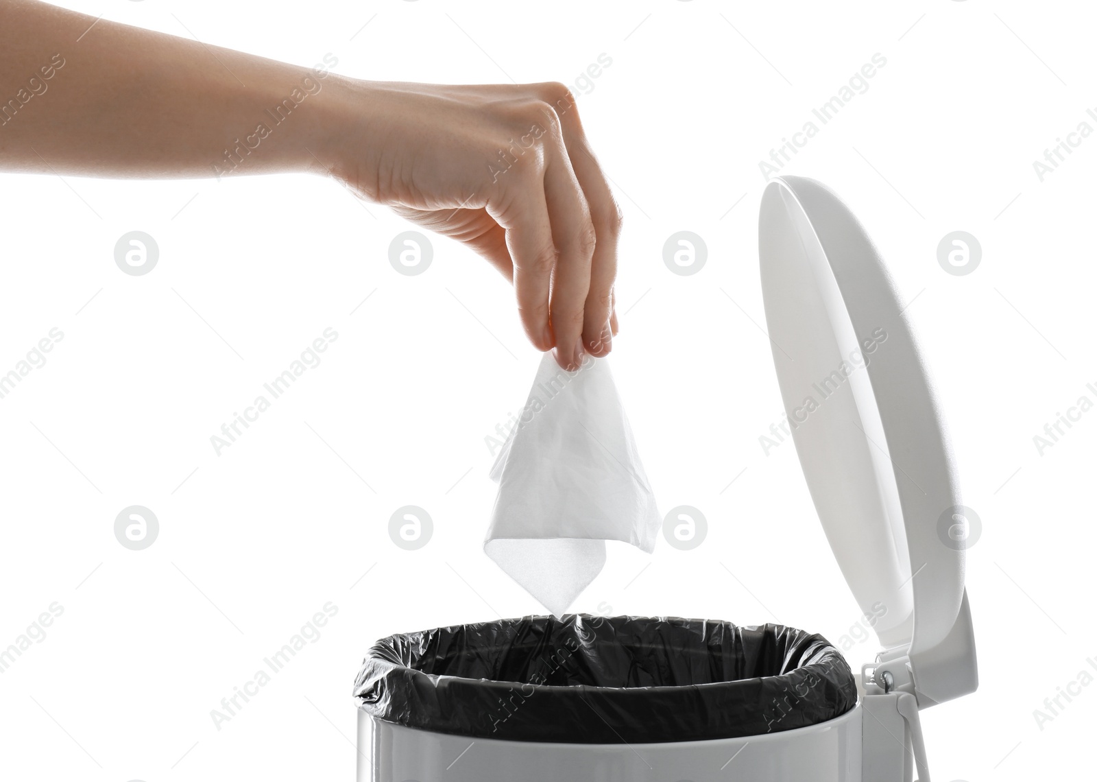 Photo of Woman putting paper tissue into trash bin on white background, closeup