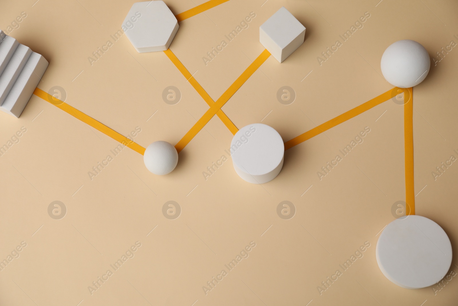 Photo of Business process organization and optimization. Scheme with geometric figures on beige background, above view