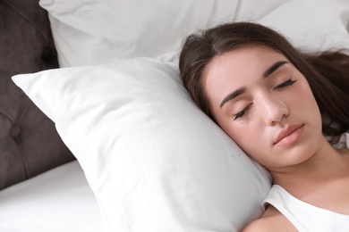 Photo of Young woman with eyelash loss problem sleeping in bed