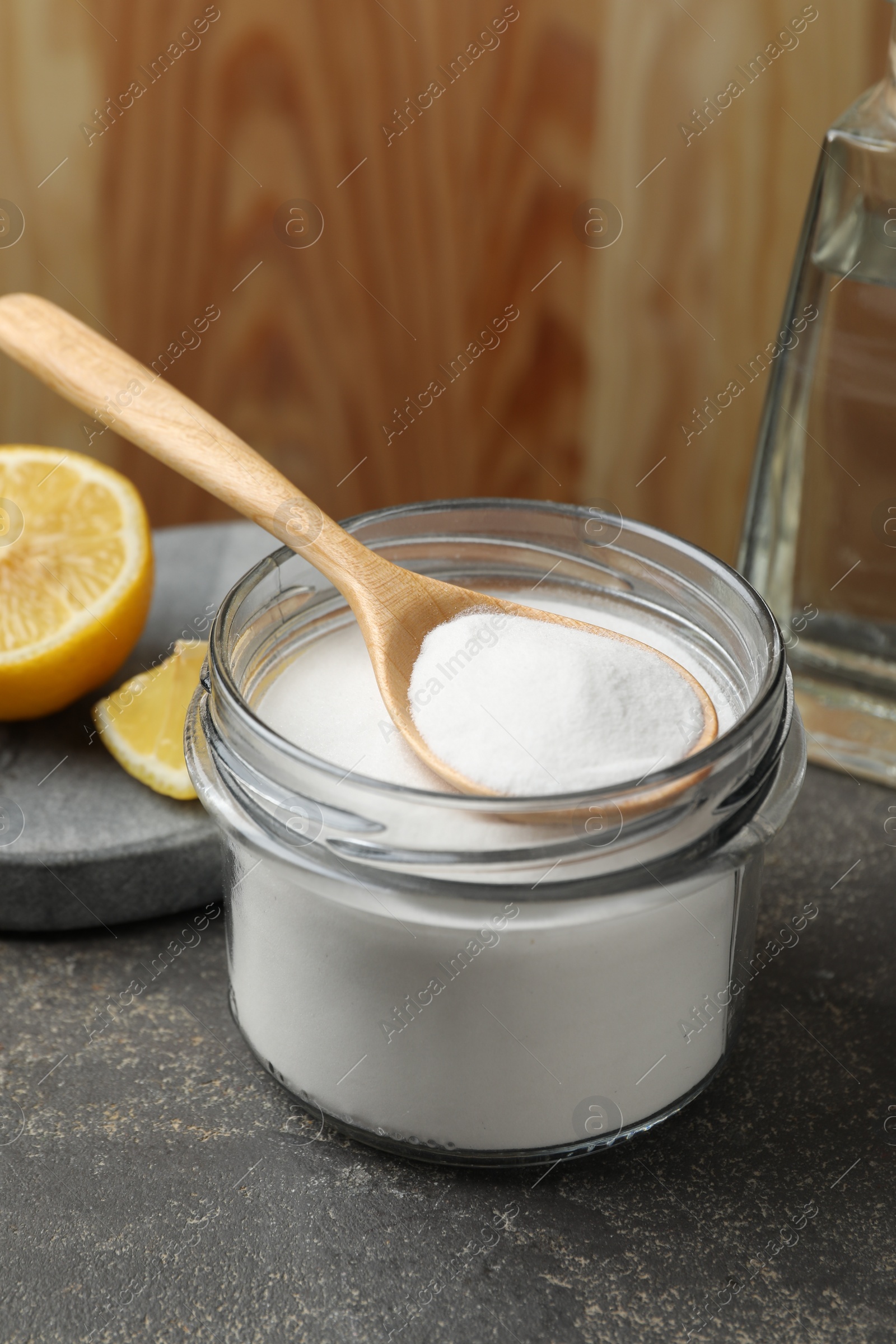 Photo of Baking soda and lemon on grey table