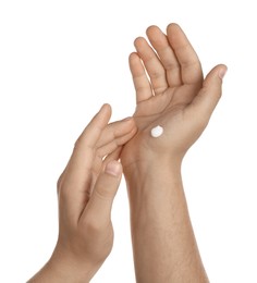 Photo of Man applying cream on hands against white background, closeup