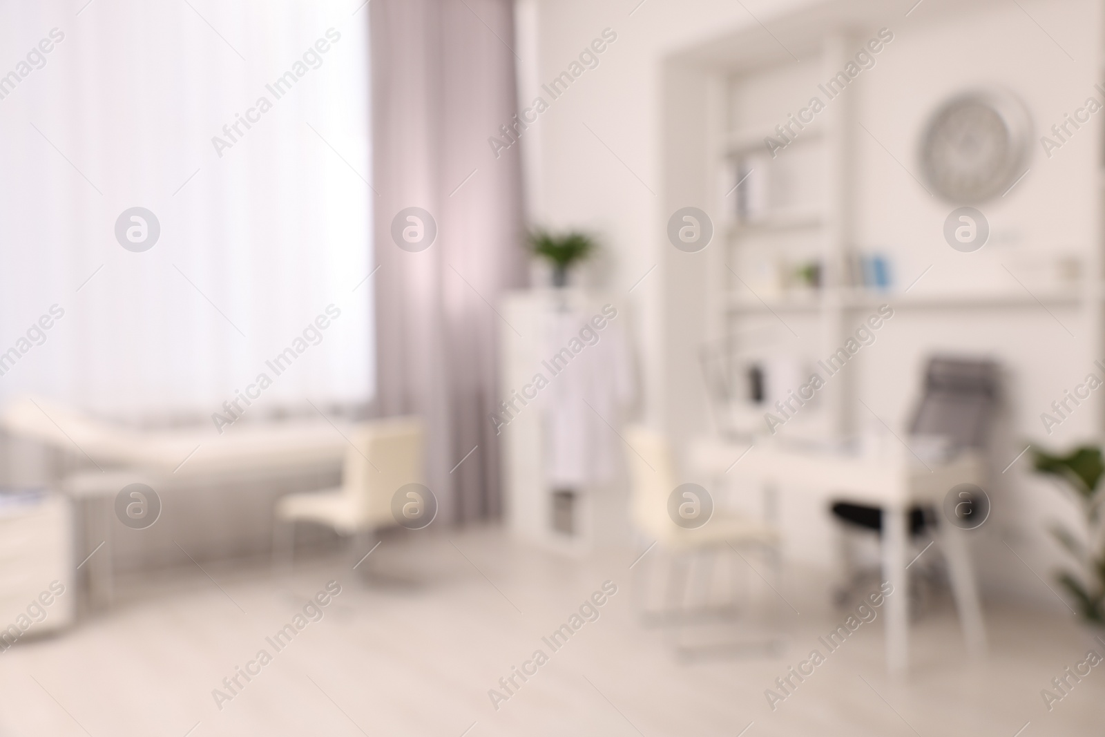 Photo of Blurred view of medical office interior with doctor's workplace