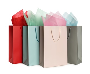 Photo of Gift bags with paper on white background