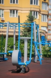 Photo of Empty outdoor gym with air walker and monkey bars in residential area