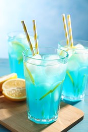 Photo of Delicious refreshing cocktail with ice on wooden table