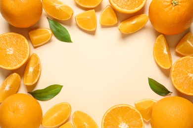 Flat lay composition with ripe oranges and space for text on color background