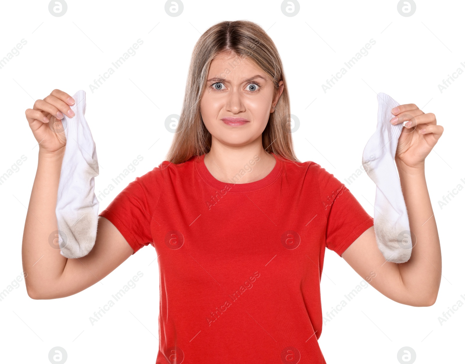 Photo of Young woman feeling bad smell from dirty socks isolated on white