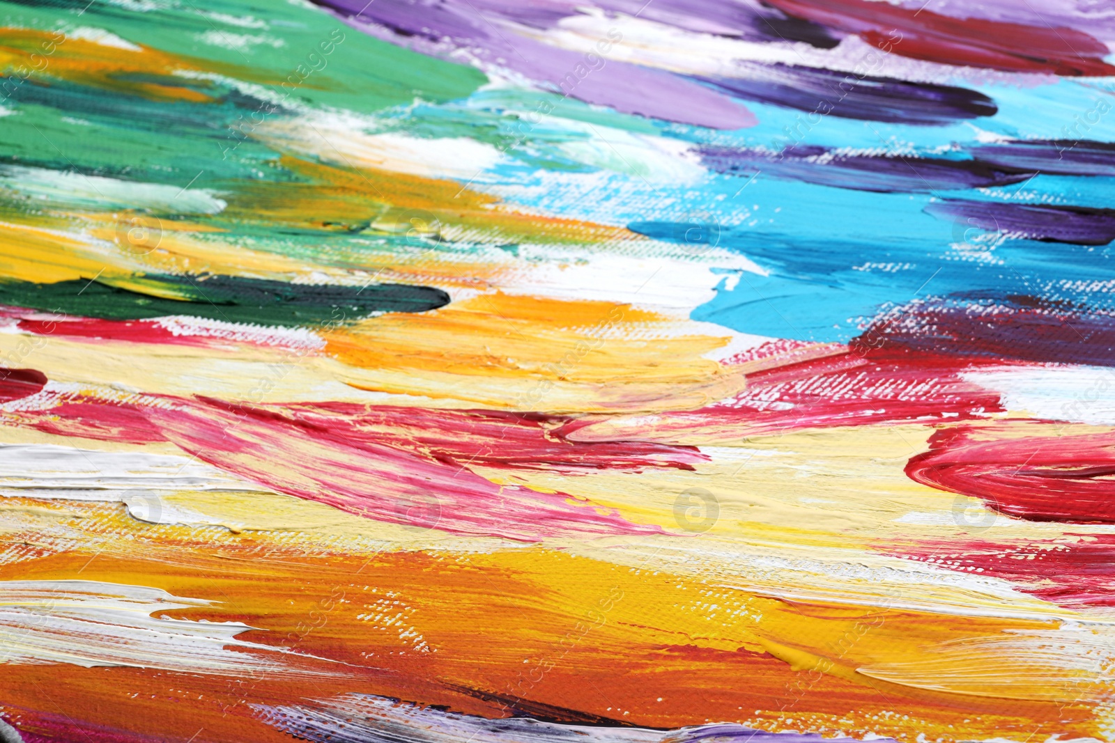 Photo of Beautiful strokes of colorful oil paints on white canvas as background, closeup