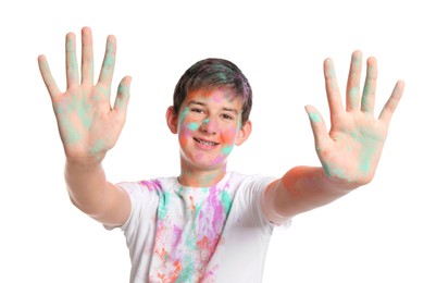 Teenage boy covered with colorful powder dyes on white background. Holi festival celebration