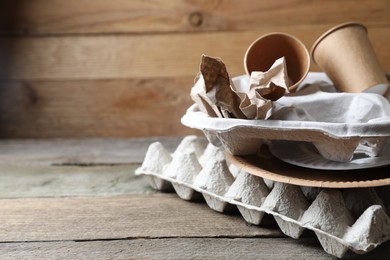 Stack of waste paper on wooden table, closeup. Space for text