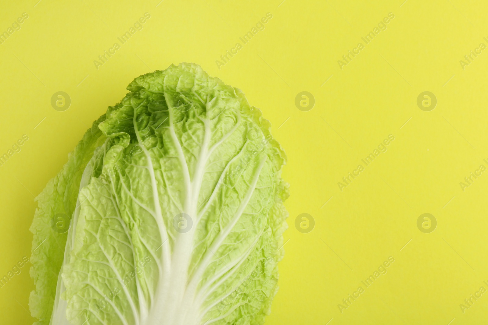 Photo of Fresh ripe Chinese cabbage on green background, top view. Space for text