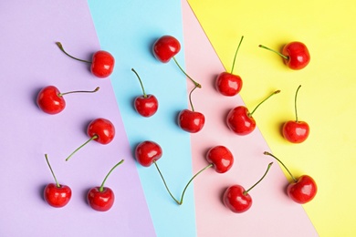 Photo of Flat lay composition with sweet cherries on color background