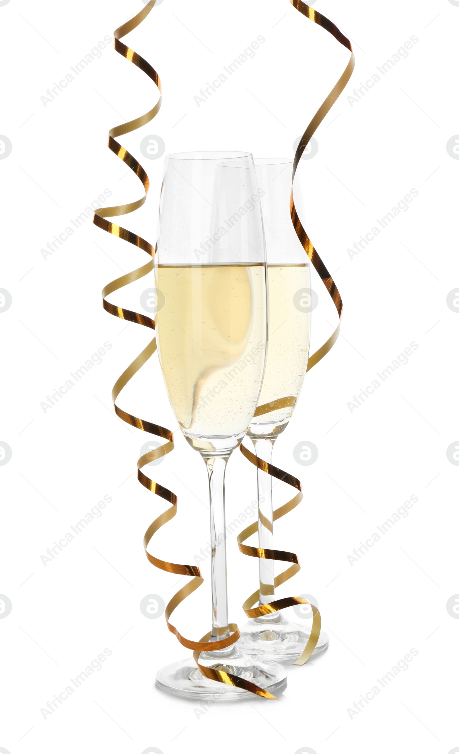 Photo of Glasses of champagne and streamers on white background
