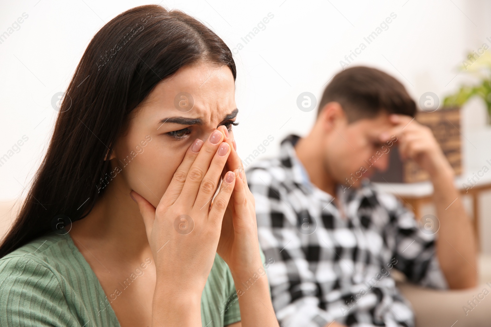 Photo of Woman crying after quarrel with her boyfriend at home. Relationship problems