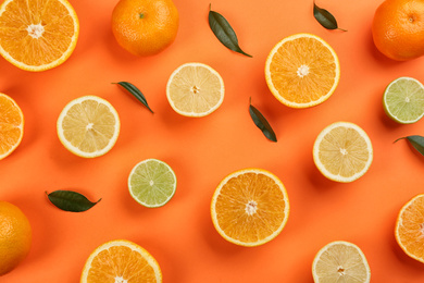 Flat lay composition with tangerines and different citrus fruits on orange background