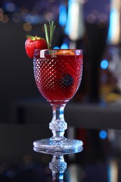 Photo of Glass of delicious refreshing sangria on counter in bar