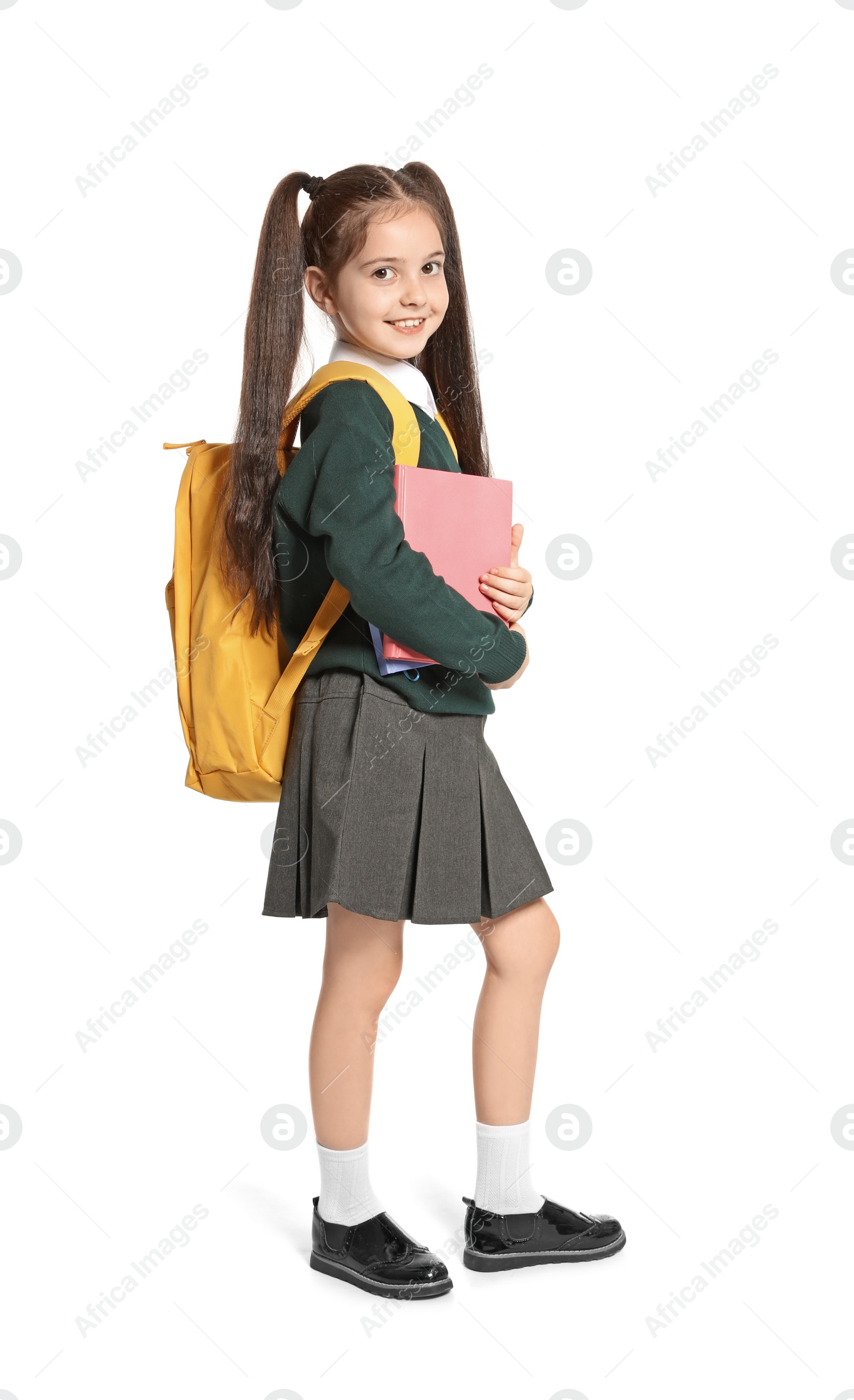 Photo of Little girl in stylish school uniform on white background