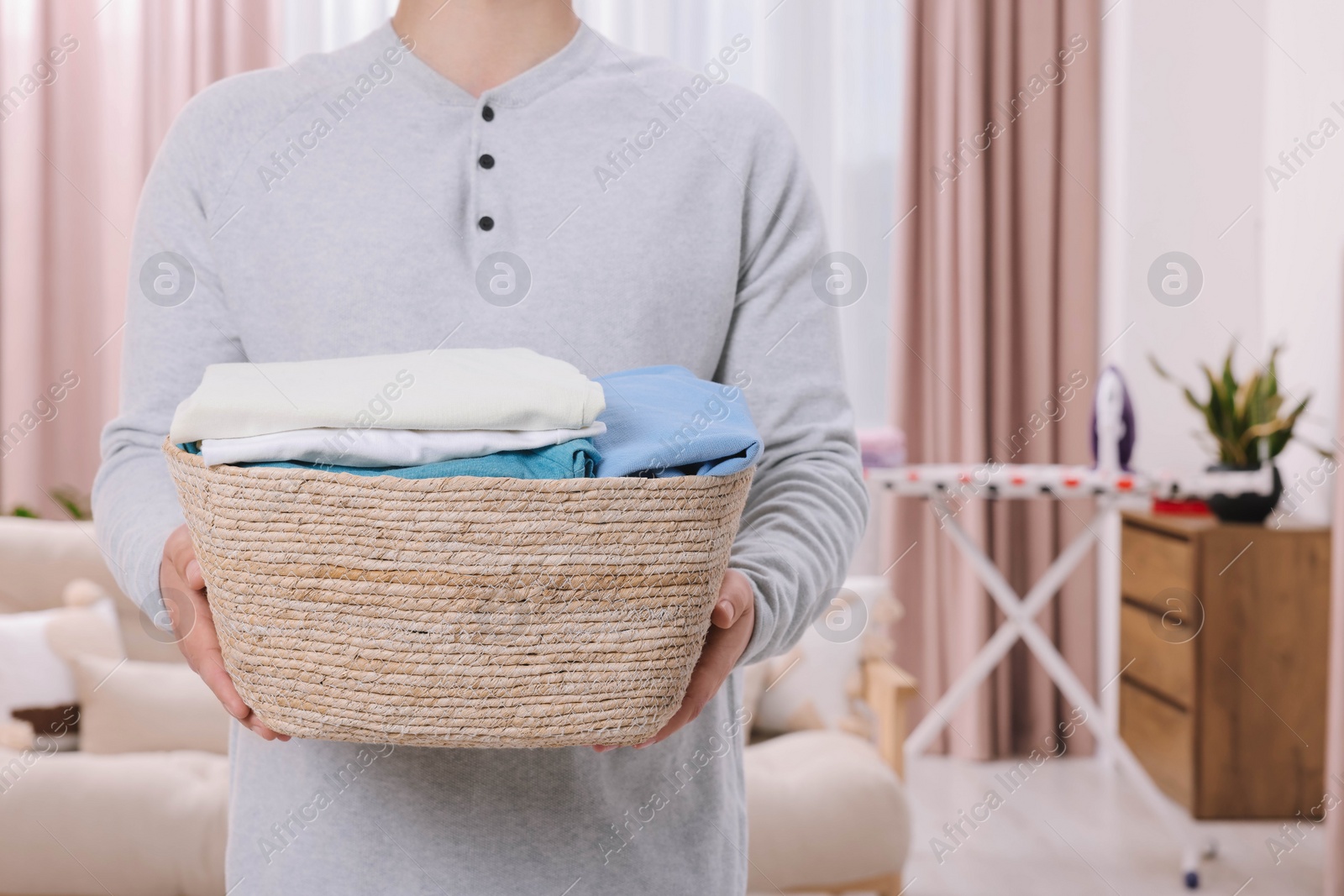 Photo of Man with basket full of laundry at home, closeup