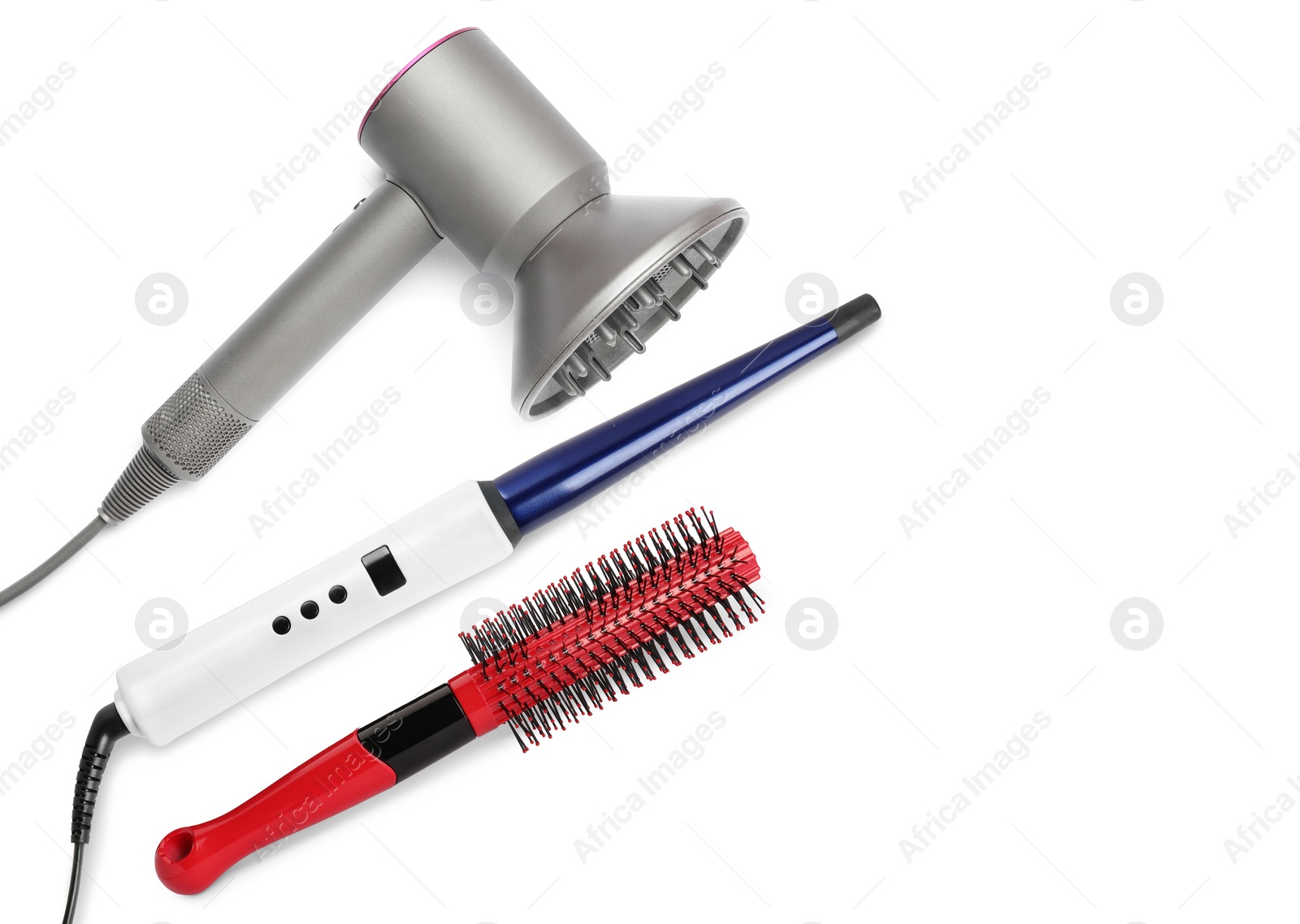 Image of Hair dryer, curling iron and brush on white background, top view