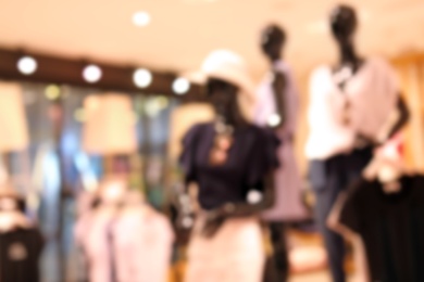 Photo of Blurred view of modern store with different clothes