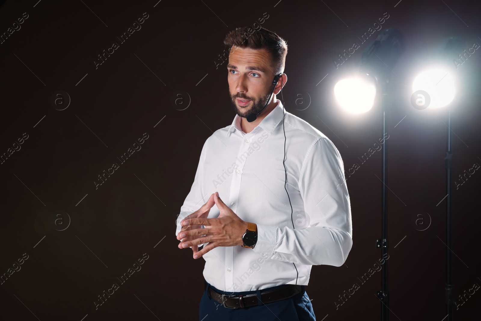 Photo of Motivational speaker with headset performing on stage