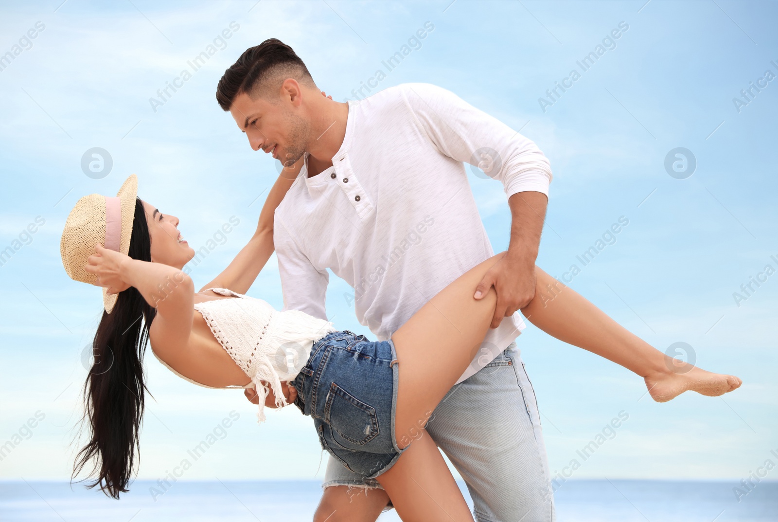 Photo of Happy couple dancing near sea in summer