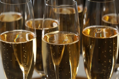 Photo of Many glasses of champagne as background, closeup view