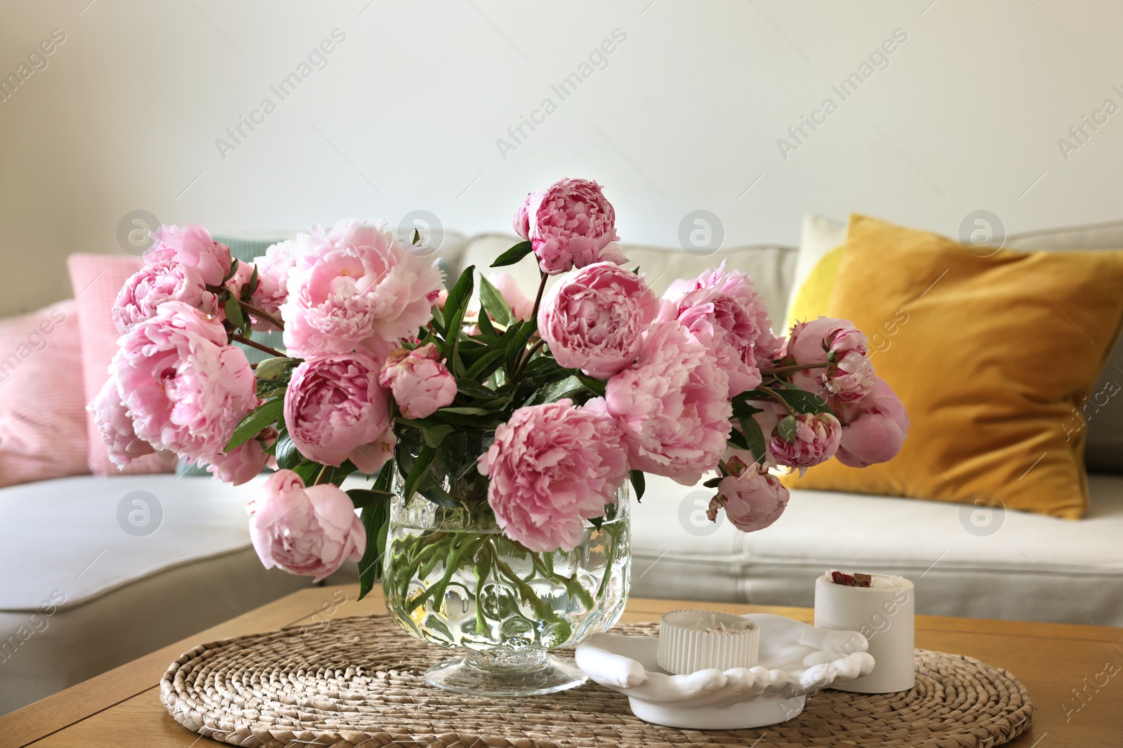 Photo of Beautiful pink peonies in vase on table at home. Interior design