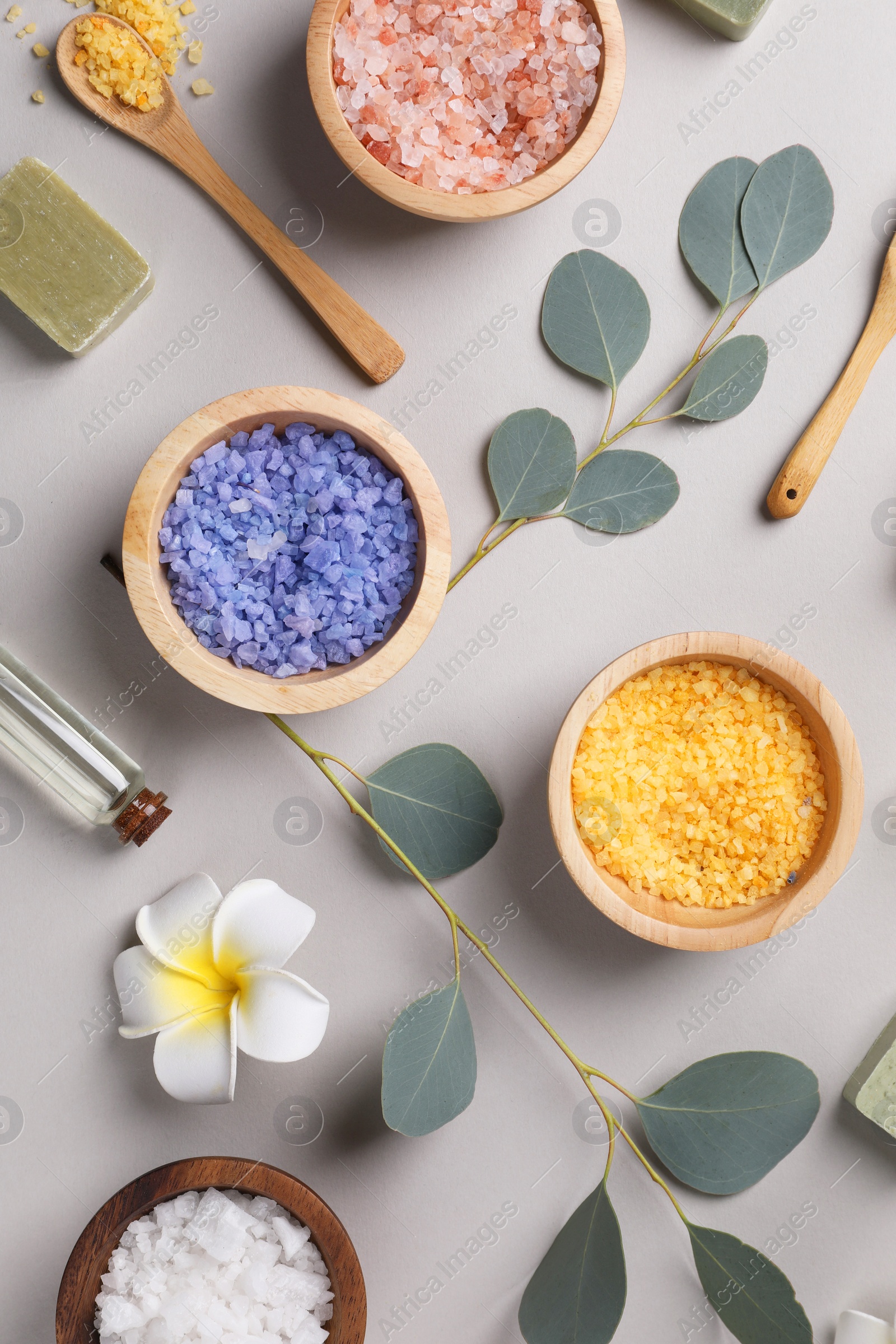 Photo of Flat lay composition with spa products and eucalyptus branches on grey background