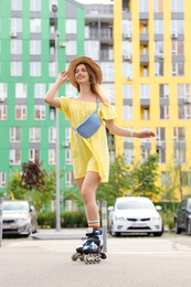 Photo of Beautiful young woman with roller skates having fun outdoors