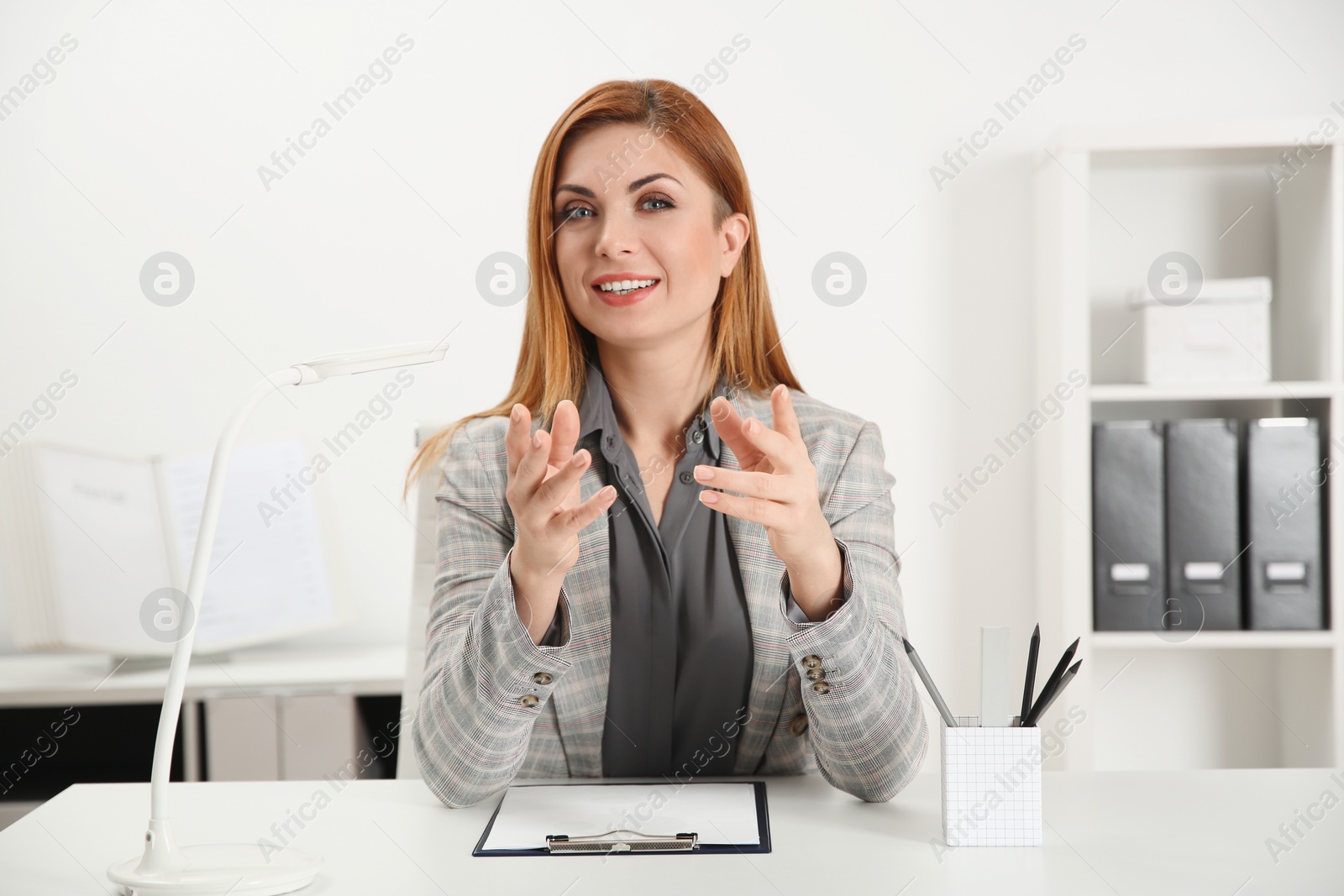 Photo of Happy woman using video chat in modern office, view from web camera